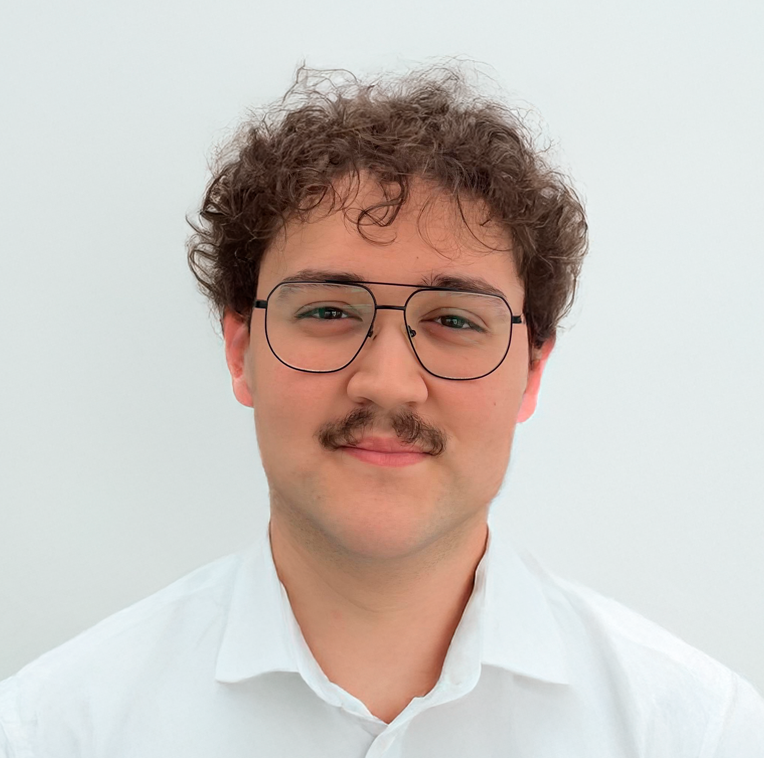 A picture of me in a white shirt with a blank background.